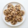 A plate of golden cookies with chocolate chips